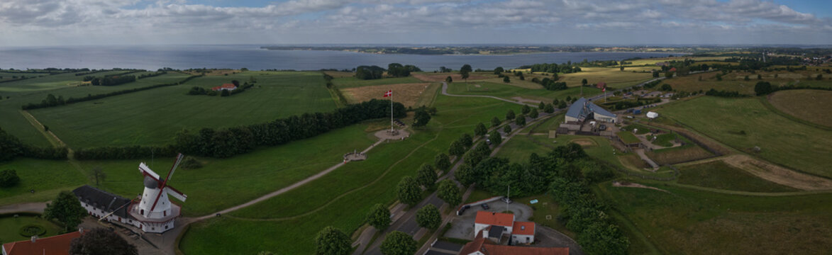 Sonderborg, Denmark - 08 July 2026: Aerial view of Dybbol Mill and the History Centre Dybbol Banke surrounded by green fields and the coastal landscape.
