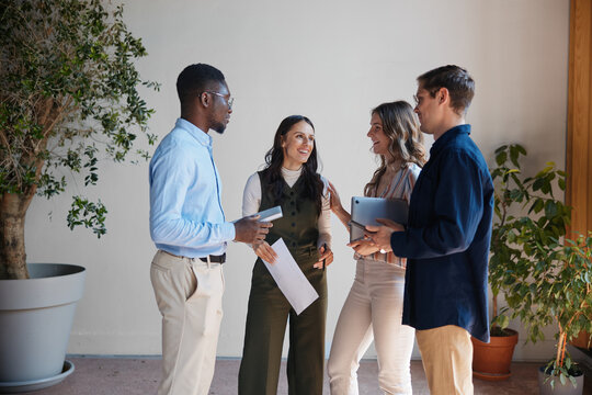 Diverse business professionals actively engaging in a casual discussion during an informal meeting. Exchanging ideas and collaborating on projects