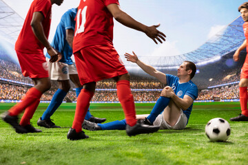 Fototapeta premium Blue soccer player lies on the pitch holding his leg after a tackle, with teammates and opponents gathering to protest the foul amid a tense football dispute following heavy contact in the match.