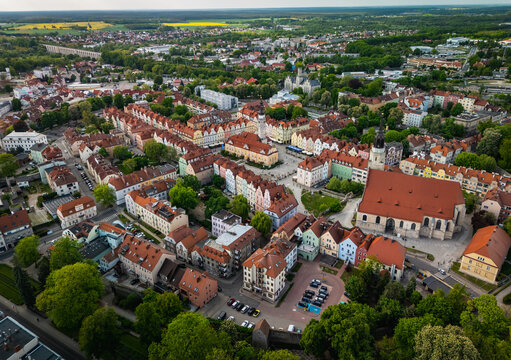 Boleslawiec, Poland - 11 May 2025: Aerial view of the historic town square, colorful buildings, and the Basilica of the Assumption of the Blessed Virgin Mary and Saint Nicholas.