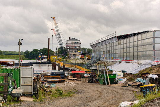 Rieseby, Schleswig-Holstein, Germany - 02 July 2026: View of the Lindaunisbrucke renovation site featuring a temporary footbridge, construction cranes, and industrial equipment along the Schlei river.