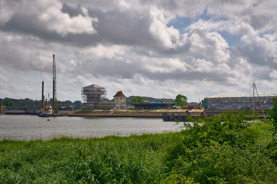 Rieseby, Schleswig-Holstein, Germany - 02 July 2026: View of Lindaunisbrucke renovation works with a temporary footbridge, construction cranes, and scaffolding along the river.