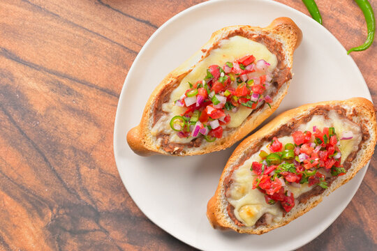 Delicious homemade Mexican molletes flat lay, traditional comfort food