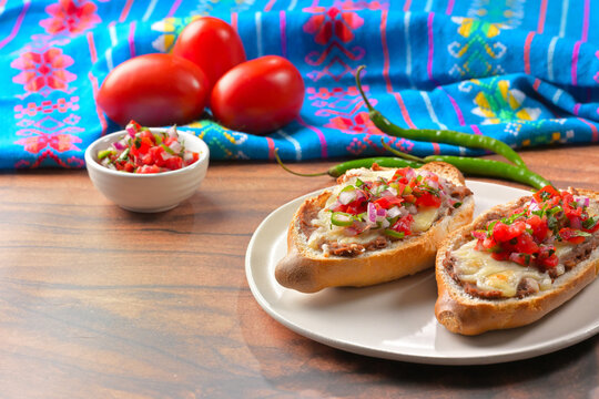 Delicious toasted bolillo bread topped with refried beans, melted cheese and tomato salsa. Mexican food