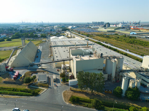 Aerial view of the Knauf UK manufacturing facility featuring industrial buildings, storage silos, and conveyor systems in Immingham, England, United Kingdom.