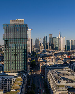Frankfurt am Main, Germany - 18 June 2026: Aerial view of the Spin Tower and the surrounding modern skyline with glass skyscrapers, urban streets, and clear blue sky in Hessen.
