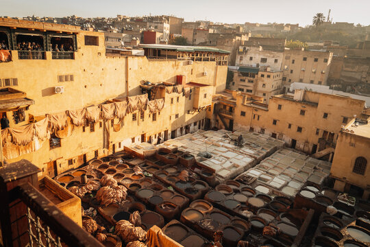 Fes, Morocco - 11 November 2025: View of the historic Chouara Tannery with its iconic stone dye pits, drying animal hides, and surrounding traditional buildings in the old medina.
