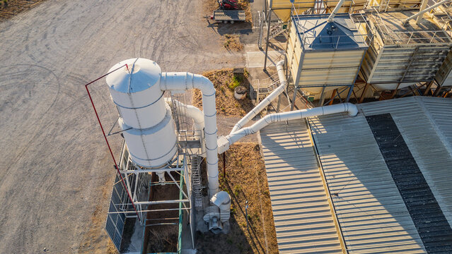Aerial view of the industrial dust collection and grain handling system at the Valgrain agricultural facility with metal silos and pipes in Saulce-sur-Rhone, Auvergne-Rhone-Alpes, France.