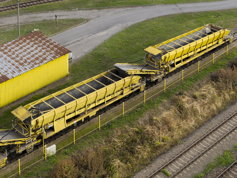 Aerial view of yellow railway maintenance machinery on tracks at a train repair station in Krakow, Lesser Poland Voivode, Poland.