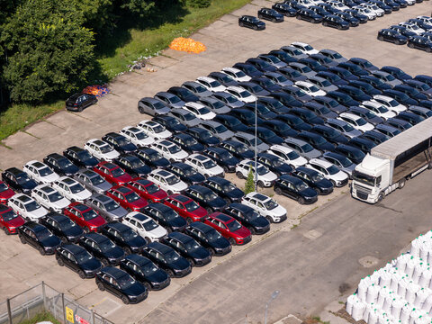 Aerial view of a New Vehicles Lined Up in Industrial Port Terminal for Global Automotive Export and International Trade Distribution
