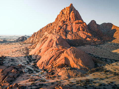 Spitzkoppe, Namibia - 10 September 2023: View of the granite rock formations of Spitzkoppe in the Namib Desert, illuminated by the warm light of the golden hour.