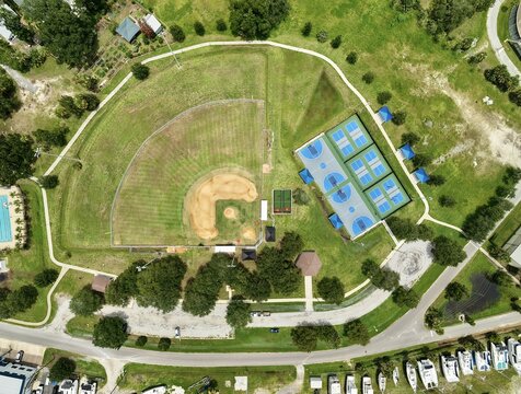 Aerial view of a public park featuring a baseball field and multiple pickleball courts near the San Sebastian River in St. Johns County, Florida, United States.