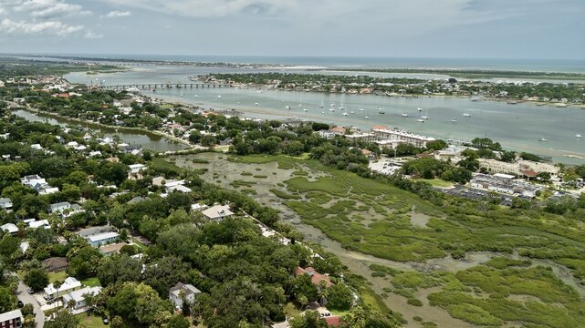 Aerial view of the San Sebastian River winding through lush green marshes and residential neighborhoods in St. Johns County, Florida, United States.