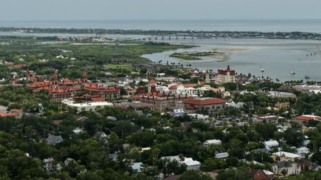 Aerial view of the historic district with red-roofed architecture of the Lightner Museum and Flagler College near coastal waterways in St. Augustine, Florida, United States.