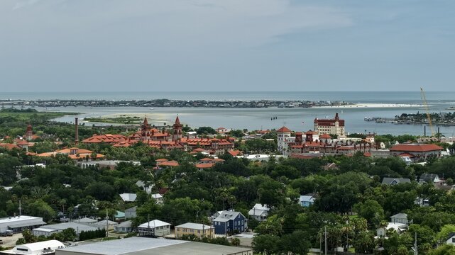 Aerial view of the historic district of St. Augustine featuring the Lightner Museum and Flagler College surrounded by lush greenery and the Matanzas Bay in St. Augustine, Florida, United States.