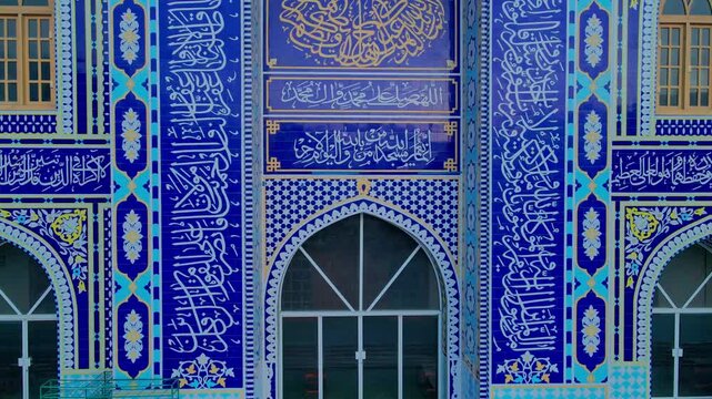 Aerial view of the Grand mosque of Skardu featuring intricate blue tile work and detailed Arabic calligraphy on the facade in Skardu, Gilgit Baltistan, Pakistan.