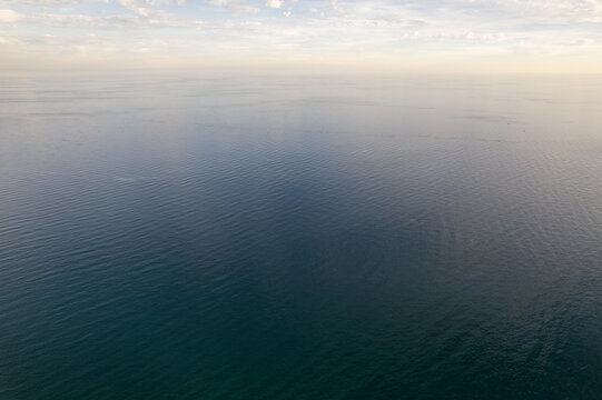 Kizkalesi, Mersin, Turkiye - 01 November 2025: Aerial view of the calm Mediterranean Sea under a soft sky.