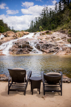 Two lounge chairs by the 5 sisters waterfalls in Eastern Belize, Central America