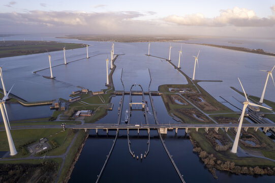 Aerial view of Krammer locks with wind turbines, water channels, and a bridge in Bruinisse, Zeeland, Netherlands.