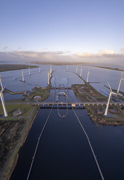 Aerial view of the Krammer locks surrounded by wind turbines and water in Bruinisse, Zeeland, Netherlands.