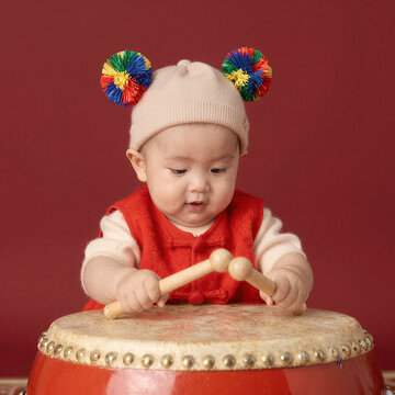 Adorable Baby Playing Chinese Drum