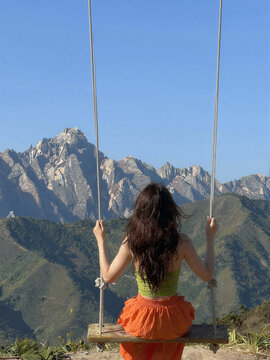 Woman Swinging Over Mountains