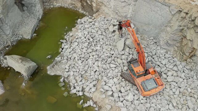 Aerial View of Excavator Breaking Rock in Quarry