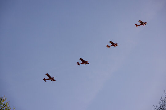 Druskininkai, Lithuania - 23 May 2026: View of four small propeller planes flying in formation against a clear blue sky.