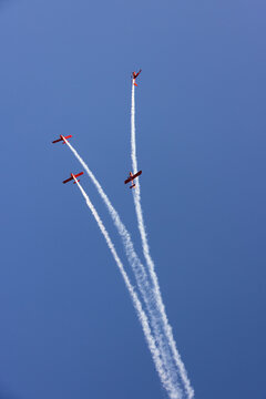 Druskininkai, Alytus County, Lithuania - 23 May 2026: View of four red aerobatic planes performing a formation flight with white smoke trails against a clear blue sky.