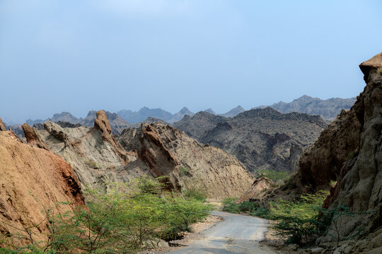 View of the rugged rocky terrain and winding road through the Sulaiman Mountains in De-excluded Area Dera Ghazi Khan, Punjab, Pakistan.