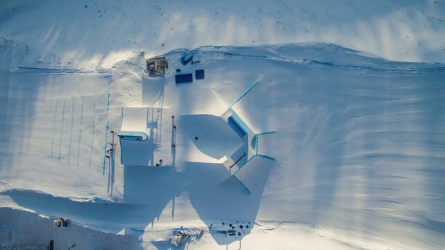 Aerial view of a snow park with ramps and rails on a snowy mountain slope in Pyongyang, North Korea.