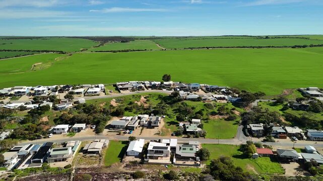 James Well, Yorke Peninsula, South Australia &ndash; 4K aerial drone view of coastal settlement, sandy shoreline, tidal reef flats, surrounding farmland, rural houses and estates.