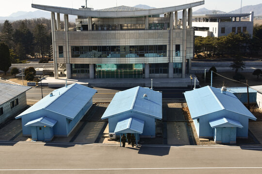 Aerial view of the blue buildings at the Joint Security Area with soldiers standing near the entrance in Pyongyang, Pyongyang, North Korea.