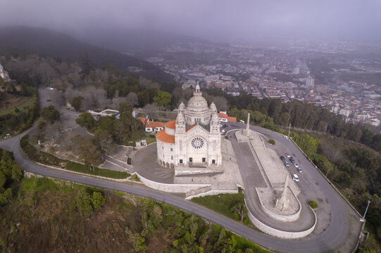 Aerial view of the Sanctuary of the Sacred Heart of Jesus on a hill overlooking the city with stone architecture and winding roads in Viana do Castelo, Viana do Castelo Dist, Portugal.