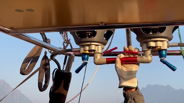 putting fire flame inside the hot air balloon, Laos, Vang Vieng	
