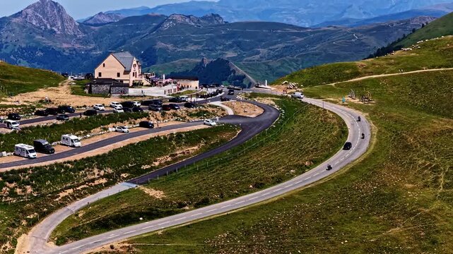 Aerial view of Col d'Aubisque featuring the mountain pass road, parking area, and surrounding peaks in Beost, Nouvelle-Aquitaine, France.