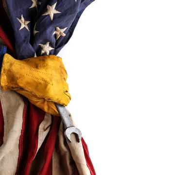 Work glove, wrench pulling back the American flag. Symbolic of blue collar workers, USA manufacturing, pride in products Made in United States of America, or celebrate Father's day or US Labor Day.