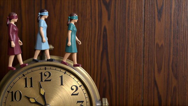 Three blindfolded figurines walk atop a vintage clock against wooden background.