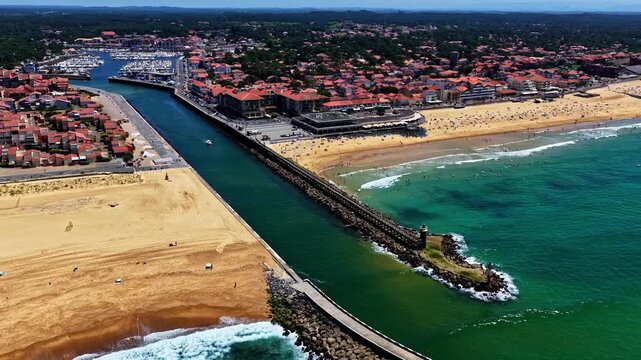 Aerial view of Port de Capbreton with its harbor, sandy beaches, and coastal buildings along the Atlantic Ocean in Capbreton, Nouvelle-Aquitaine, France.