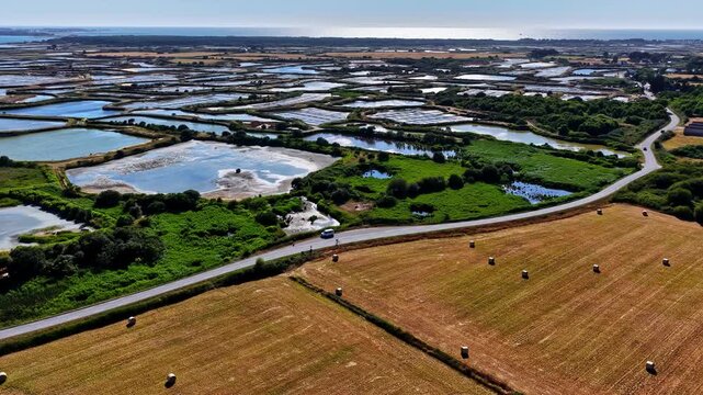 Aerial view of salt marshes and agricultural fields with hay bales in Capbreton, Nouvelle-Aquitaine, France.