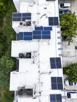 Aerial view of private solar panels on a white rooftop in Merida, Yucatan, Mexico.