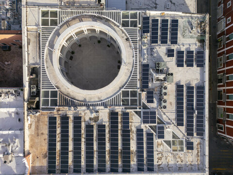 Aerial view of a building rooftop in the old town featuring a large circular courtyard and rows of solar panels in Merida, Yucatan, Mexico.