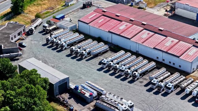 Aerial view of a fleet of tanker trucks parked in rows at a logistics facility near the Port of Bordeaux in Bassens, Nouvelle-Aquitaine, France.
