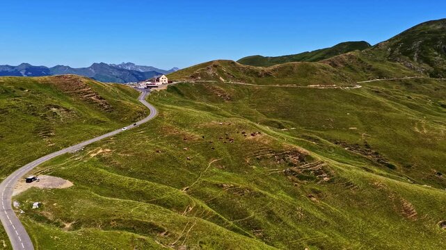 Aerial view of winding road at Col d'Aubisque through green mountain slopes in Beost, Nouvelle-Aquitaine, France.