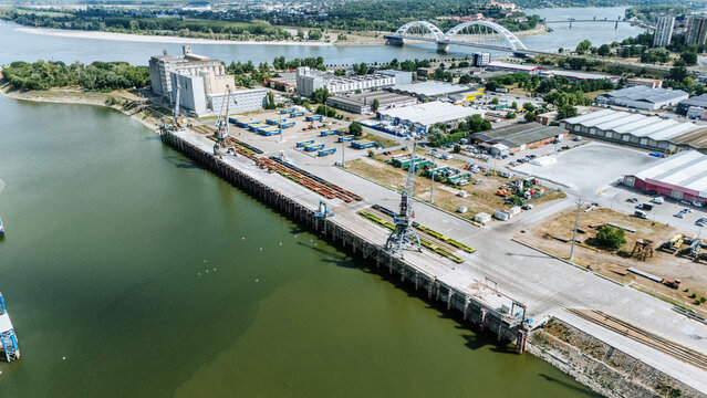 Aerial view of Luka Novi Sad port facilities with industrial cranes, shipping containers, and warehouses along the Danube River in Novi Sad, Vojvodina, Serbia.