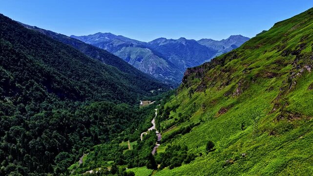 Aerial view of the winding road through the lush green mountains of the Col d'Aubisque in Beost, Nouvelle-Aquitaine, France.