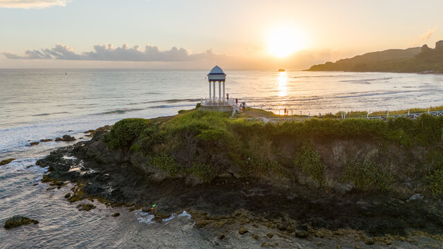 Aerial view of the gazebo at La Puntilla overlooking the Caribbean Sea at sunset with rocky coastline and lush vegetation in Puerto Plata, Puerto Plata Province, Dominican Republic.