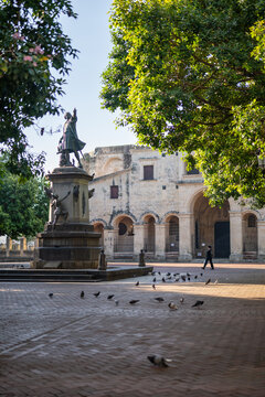Aerial view of the Christopher Columbus statue in the historic Zona Colonial plaza, with brick ground and architecture in Santo Domingo, Distrito Nacional, Dominican Republic.