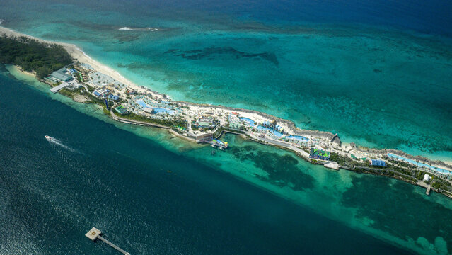Aerial view of Atlantis Paradise Island resort complex featuring turquoise waters, swimming pools, and white sandy beaches in Nassau, New Providence, The Bahamas.
