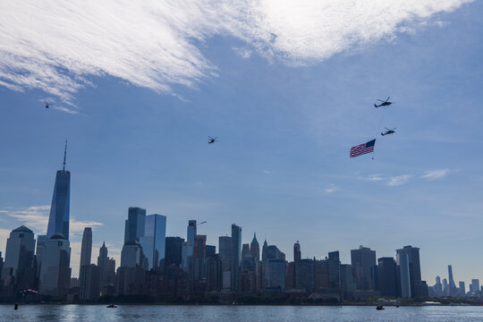 Jersey City, New Jersey, United States - 04 July 2026: View of military helicopters carrying an American flag over the Hudson River with the Manhattan skyline seen from Liberty State Park.